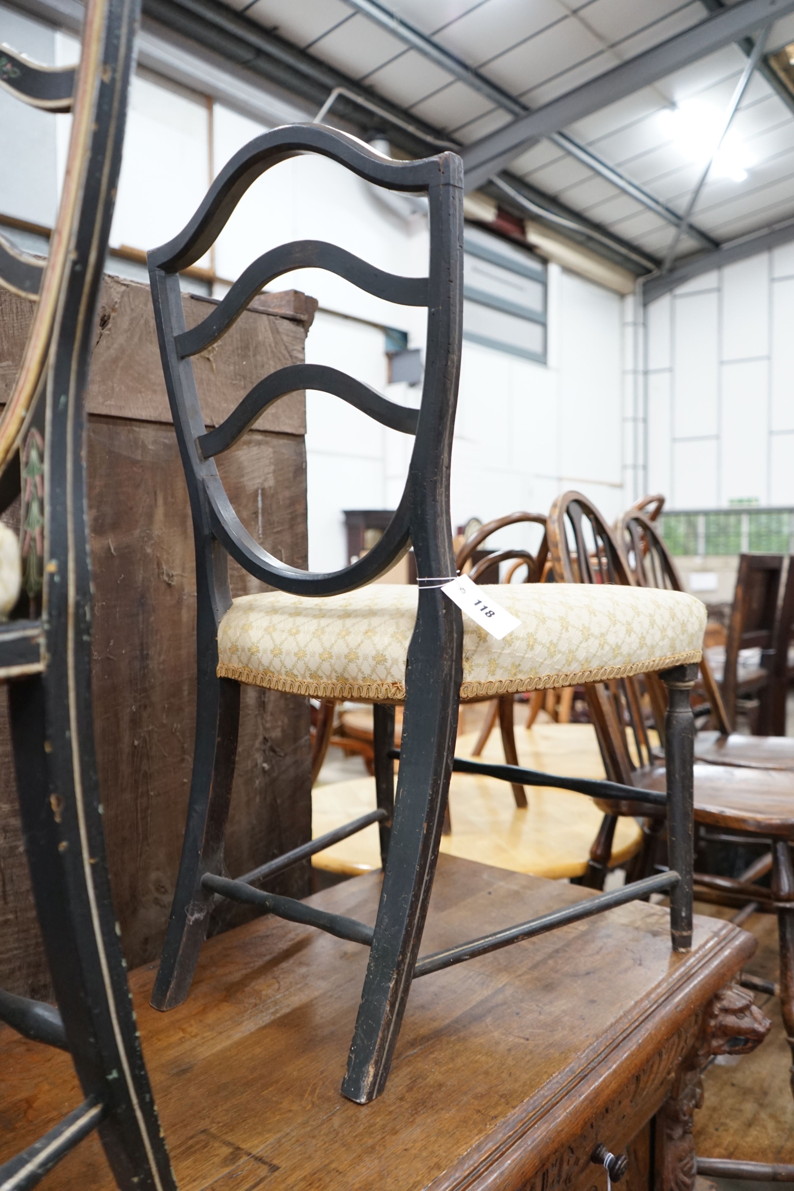 A George III provincial painted cane seat chair and another